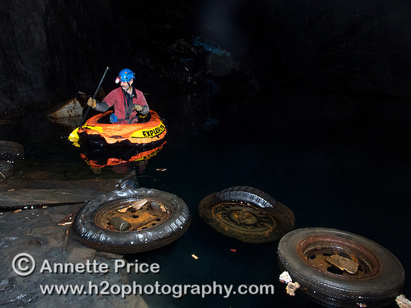 Peter Hamilton paddles past floating wheels towards the car graveyard. Gaewern Slate Mine.