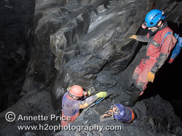 Caver Neil Montgomery (left) climbing down the "sling ladder" with  Peter Hamilton (right)