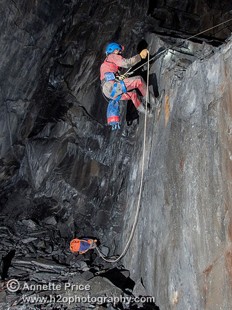 Peter Hamilton doing the short abseil to reach the bottom of the mine workings. Gaewern Slate Mine.