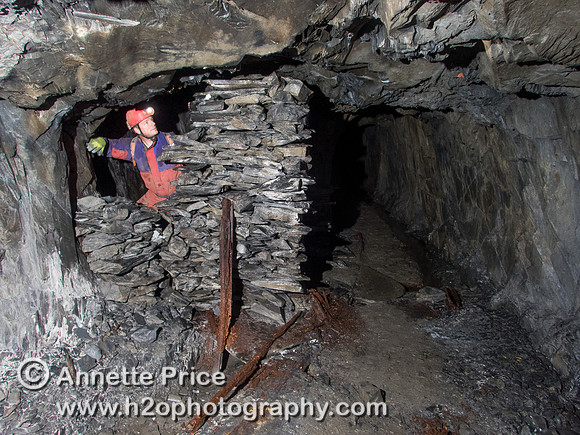 Neil Montgomery inside the small stone, walled hut, Gaewern Slate Mine. North Wales, UK