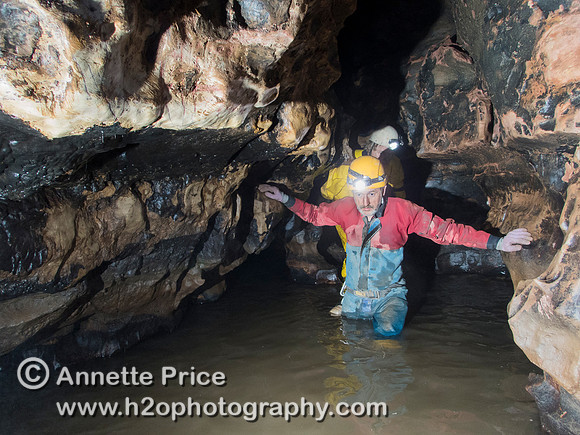 Paul Stacey wading through the streamway in Slaughter Stream Cave, South Wales, UK