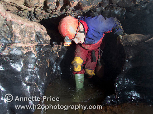Caver Neil Montgomery in Slaughter Stream Cave, South Wales, UK