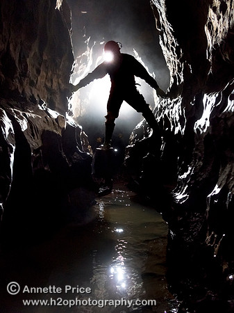 Caver in Slaughter Stream Cave, South Wales, UK