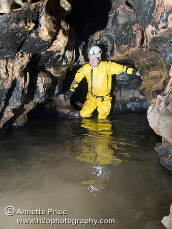 Chris Crowley wading through the streamway in Slaughter Stream Cave, South Wales, UK