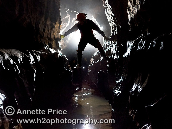 Caver in Slaughter Stream Cave, South Wales, UK
