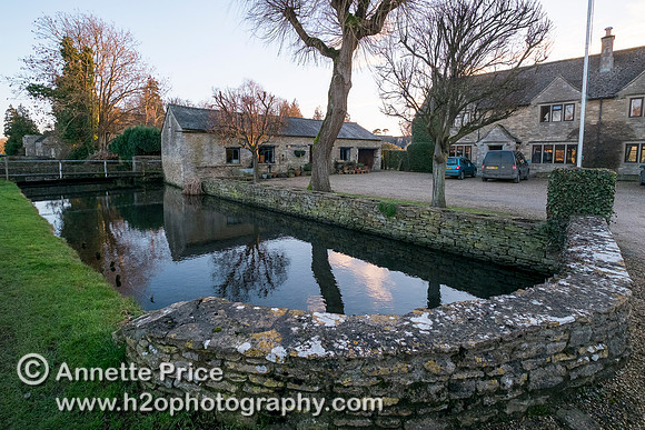 Ashton Keynes.  Most houses on the west side of the High Street have their own bridge over Thames.